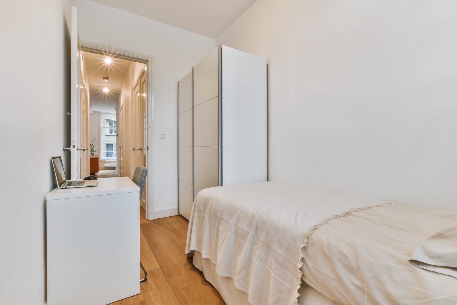 small UK box room bedroom with single bed, narrow desk and slim wardrobe storage